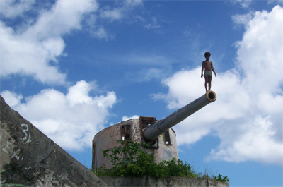 Tarawa Boy Standing on Cannon